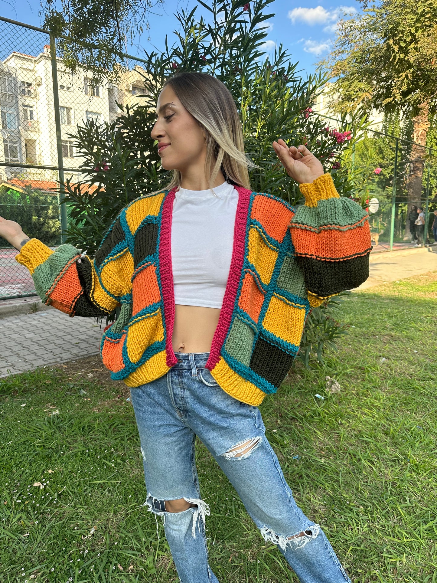 patchwork cardigan, cozy knitwear, colorful cardigan, soft yarn sweater, relaxed fit style, vibrant statement piece, must-have layering item, handmade charm, bold color combination, trendy fall fashion