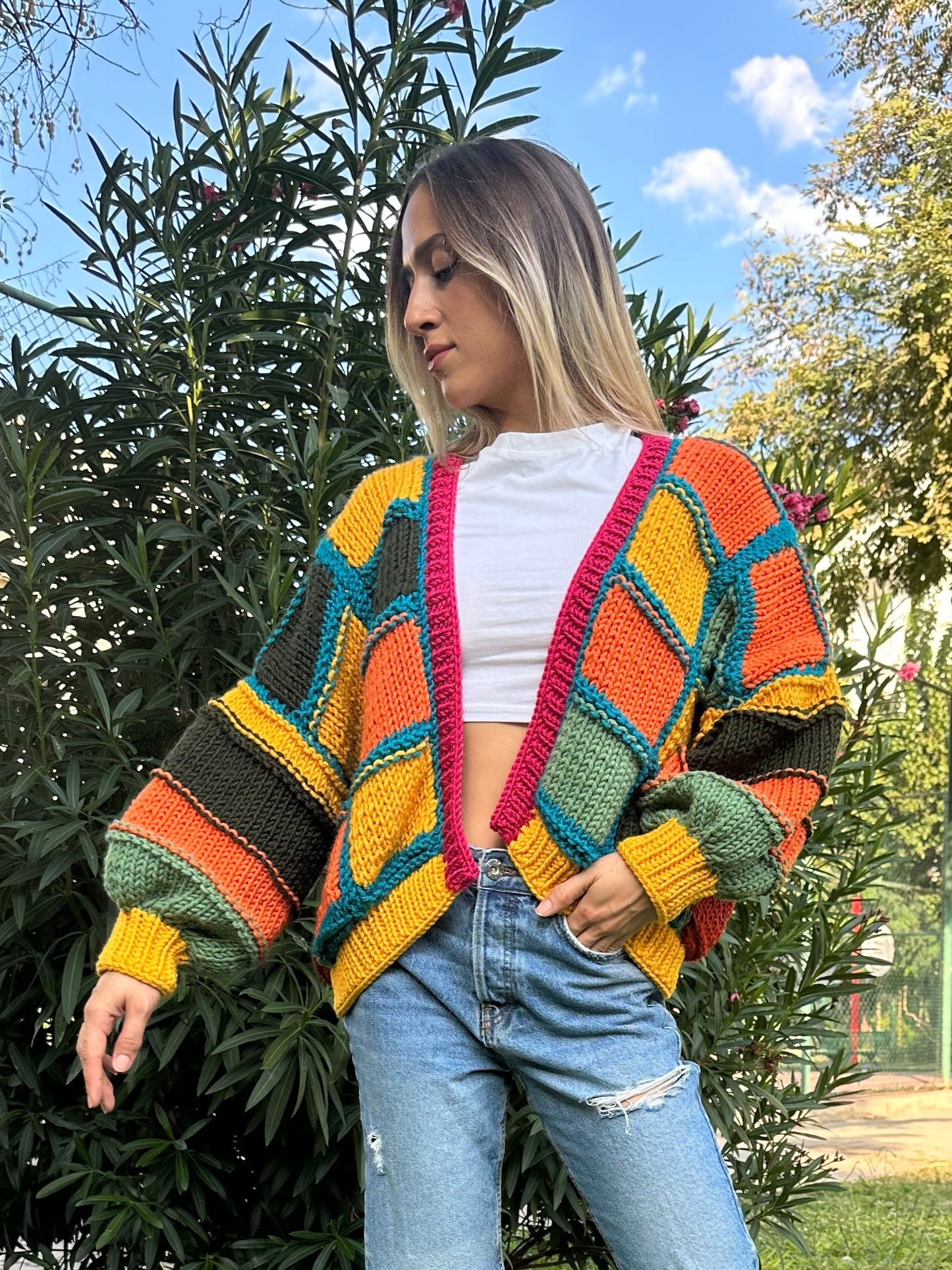 patchwork cardigan, cozy knitwear, colorful cardigan, soft yarn sweater, relaxed fit style, vibrant statement piece, must-have layering item, handmade charm, bold color combination, trendy fall fashion