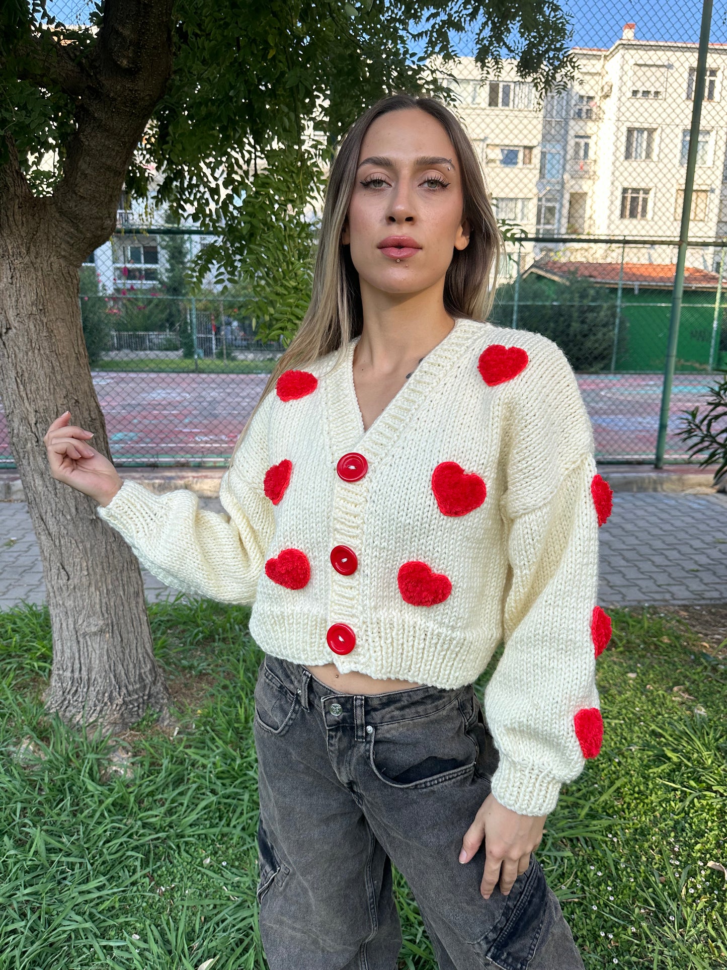 white heart cardigan, Valentina cardigan, cozy knit sweater, red heart design, soft fabric cardigan, relaxed fit sweater, playful heart details, casual knitwear, stylish layering piece, cheerful winter cardigan