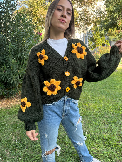 military green cardigan, sunflower knit cardigan, cozy green sweater, hand-knitted sunflowers, relaxed fit cardigan, soft yarn sweater, casual knitwear, earthy tone cardigan, unique floral design, stylish layering piece